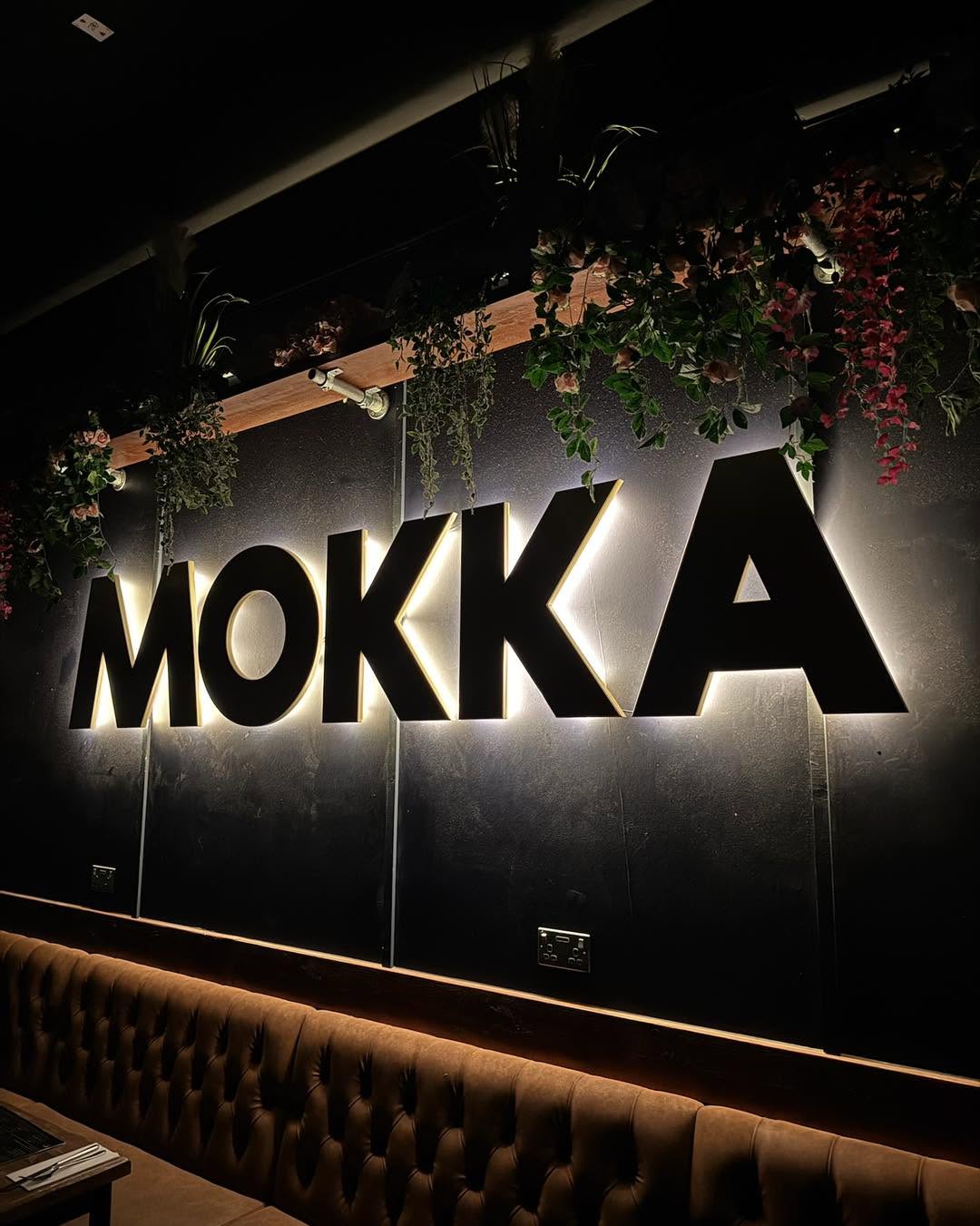Rustic cafe interior with glowing Mokka sign